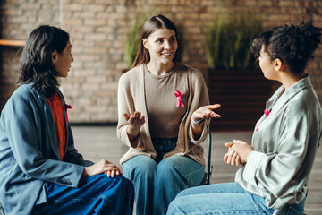 Multinational women supporting each other during breast cancer awareness month