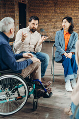 Counselor leading support group therapy session for people with disabilities