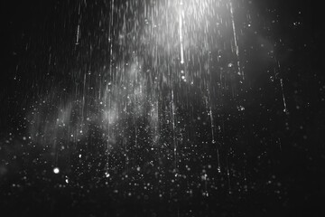 Abstract grayscale image of falling particles