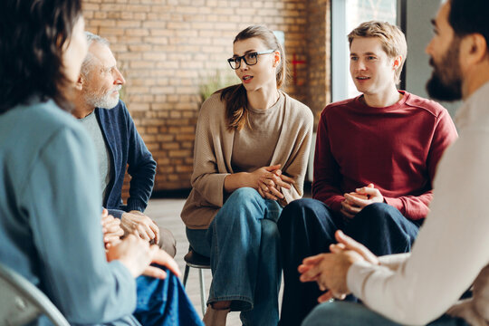 Diverse group of people sharing and discussing in support group meeting