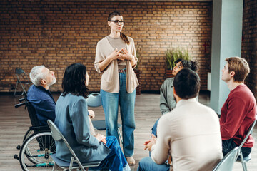 Counselor leading group therapy session for diverse patients