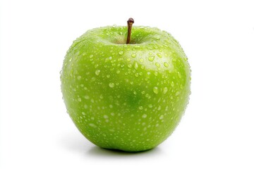 A green apple covered in water droplets stands on a white surface The apple is round with a brown stem