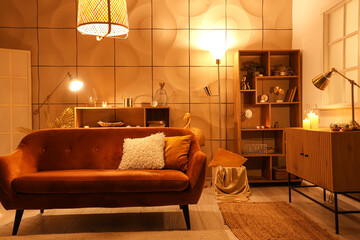 Interior of stylish living room with glowing lamps and sofa at night