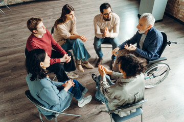 Diverse group of people participating in support group meeting