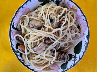 evocative close-up image of a homemade spaghetti with mussels