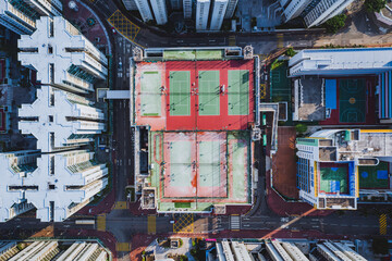 Aerial of tennis court on a rooftop among high rise buildings, Hong Kong