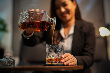 Closeup business woman holding a glass of whiskey