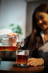 Closeup business woman holding a glass of whiskey