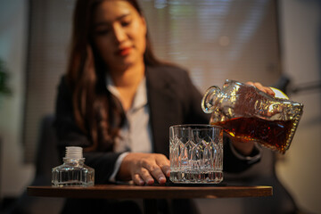 Closeup business woman holding a glass of whiskey