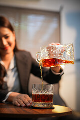 Closeup business woman holding a glass of whiskey