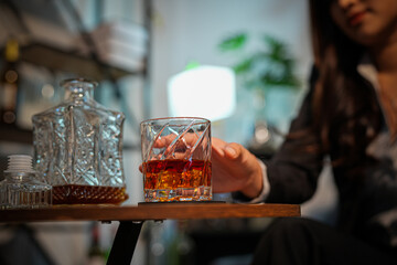 Closeup business woman holding a glass of whiskey