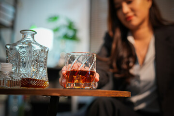 Closeup business woman holding a glass of whiskey