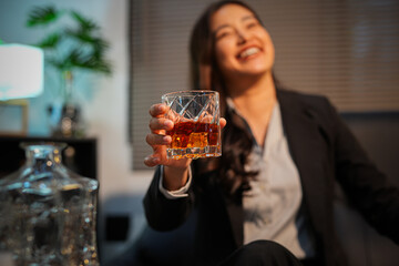 Closeup business woman holding a glass of whiskey