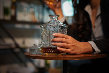 Closeup business woman holding a glass of whiskey