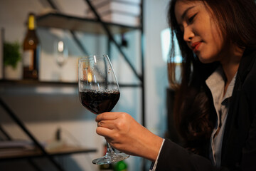Closeup business woman holding a glass of wine