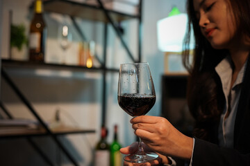 Closeup business woman holding a glass of wine