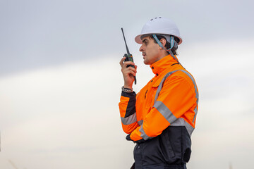 Maritime Safety Engineer Working at Port Terminal with Walkie Talkie, Dock Worker in Safety Uniforms Using Technology for Port Operations, Industrial Engineer Collaborating at Harbor Site