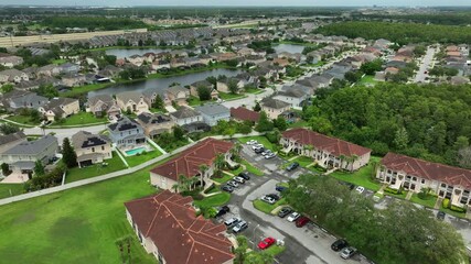 Aerial establishing shot over noble and luxury suburb neighborhood of Orland, Florida. Luxury villas and homes with private lake in yards. peaceful community lifestyle of USA. Top down