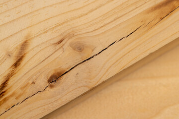 old wooden board with cracks, a pine wood board cracked during operation, closeup