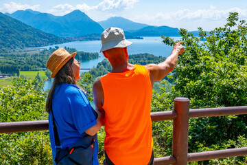 Mergozzo Lake, Tourist enjoys leisurely walk along Montorfano village, Hiking couple enjoying scenic mountain view, Province Verbano-Cusio-Ossola in Italian region Piedmont, Italian lakeside town
