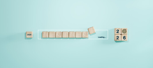 Wooden blocks showing transition from 2025 to 2026 with progress loading bar and goal icon. Concept of new year planning, future vision, and setting annual objectives.