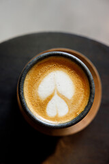 Cup of milk latte coffee on table by the street.