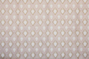 Old wallpaper on the wall. Old wallpaper for texture or background.