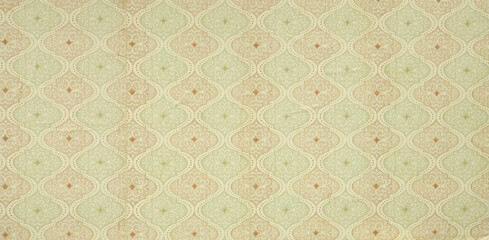 Old wallpaper on the wall. Old wallpaper for texture or background.