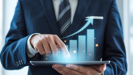 A businessman uses a tablet to analyze a growing graph, symbolizing business success and growth
