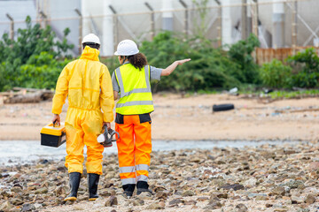 Back View of Researchers Testing Water Quality at a Lake or Coastal Area, Environmental Scientists Collecting Water Samples for Analysis, Water Pollution Control, Scientists at Work in the Field