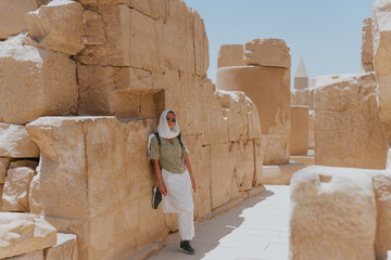 Tourist exploring ancient ruins of karnak temple complex in luxor, egypt
