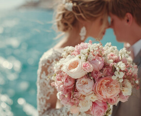 Newlyweds with a bouquet near the ocean 