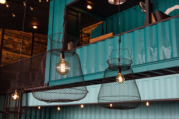 Industrial Style Pendant Lamps with Mesh Design and Exposed Bulb. Contemporary interior of...