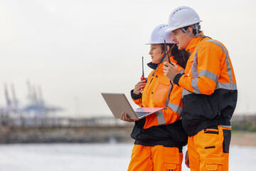 Dock Worker in Safety Uniforms Using Technology for Port Operations, Maritime Safety Engineers...