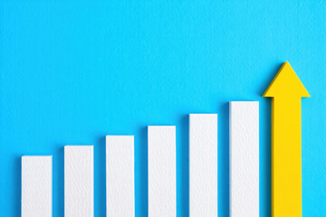 Ascending Heights A Visual Representation of Growth and Progress with a Yellow Arrow Symbolizing Upward Trajectory Against a Serene Blue Backdrop of Success