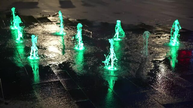 Colorful water fountain dance show with laser light.