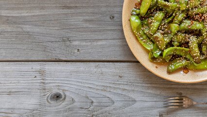 Asian style pea pods stir-fried with garlic, ginger, and soy sauce, and sprinkled with toasted...