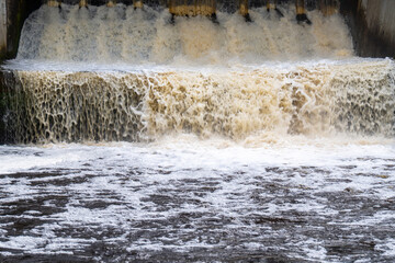 Foaming Waterfall from Hydroelectric Dam – Abstract Close-Up of Rushing Water and Energy Flow in...