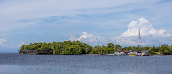 A panoramic view of a fishing village and mangrove forest along a river in Kuala Penyu, Sabah,...