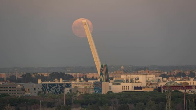 Day to Night Timelapse of Moon Passing Over Puente del Alamillo Monument at Sunset in Seville

