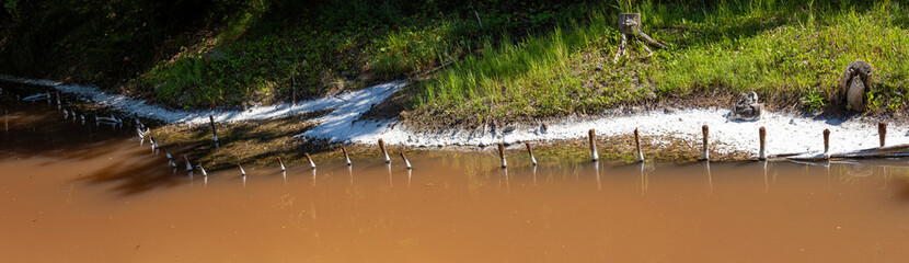 Shore of a saltwater lake with crystallized salt on the ground