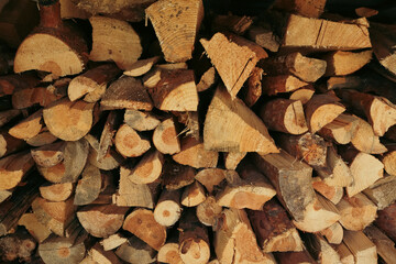 Stacked firewood background with textured logs. Cut firewood front view.