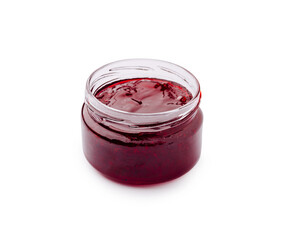 Freshly made raspberry jam in a glass jar on a white background