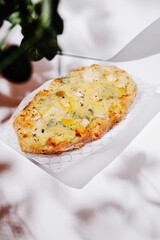 Delicious flatbread topped with cheese and herbs served on a plate