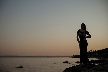 A person standing in front of a body of water