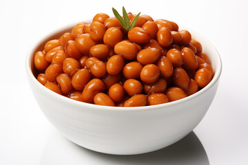 cooked brown beans served in white bowl with fresh mint on table top