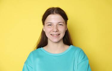 Portrait of teenage girl on yellow background