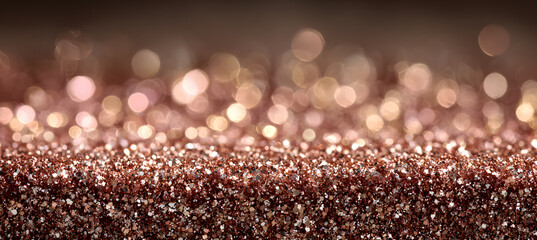Rose gold background with sparkling rose gold glitter dust at the bottom, warm golden-pink bokeh light reflections, elegant and modern festive style.