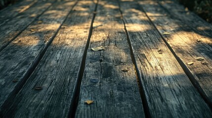 Fototapeta premium Rustic Wooden Decking with Sunlight and Scattered Leaves, Ideal for Backgrounds and Textures