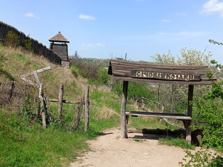 View from the foot of the hill on the ancient wooden fence surrounding the outbuildings of the Zaporizhian Sich.